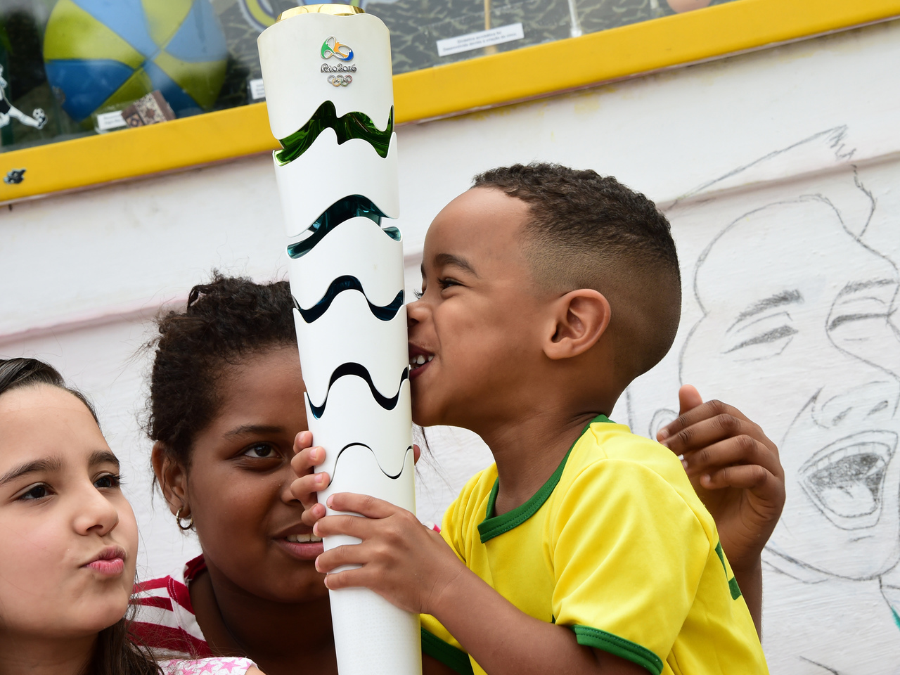Children from the neighborhood play at sports enthusiast Jarbas Meneghini's home in Campo Grande, Rio de Janeiro, Brazil on August 9, 2016. Menenghini, a 47-year-old mechanic who when he was young wanted to be a footballer, has turned his home into a sort of museum of the Olympic Games and the football World Cup and where every Sunday since last month, the children from the neighborhood gather to play the "Olympic Games". / AFP PHOTO / TASSO MARCELO