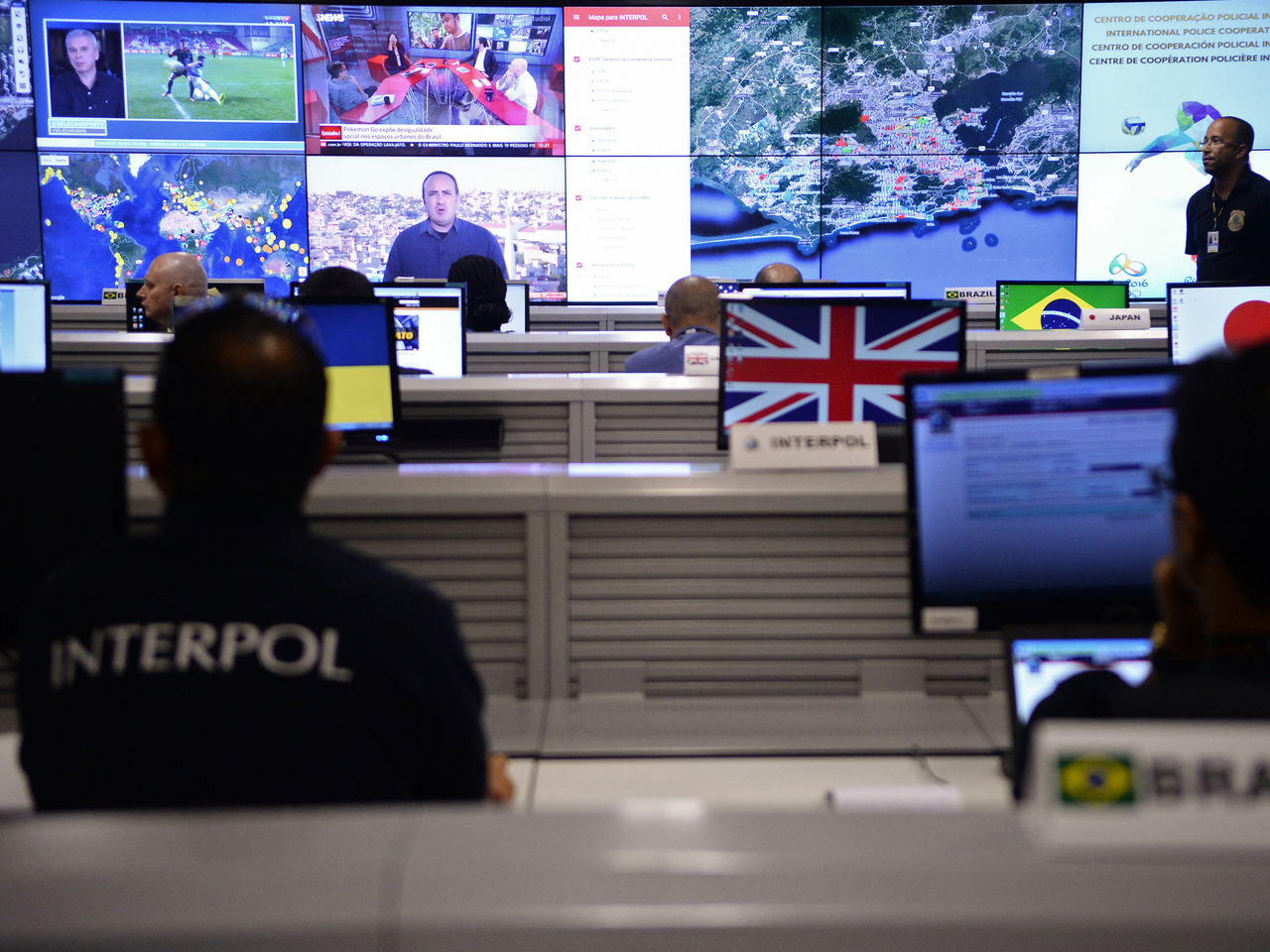 Interpol officers work at the International Police Cooperation Center (CCPI) in Brasilia, on August 1, 2016, during its inauguration.The centre will work during the Olympic and Paralympic Games in Rio de Janeiro, which will take place from August 5-21 and September 7-18 respectively..  / AFP PHOTO / ANDRESSA ANHOLETE